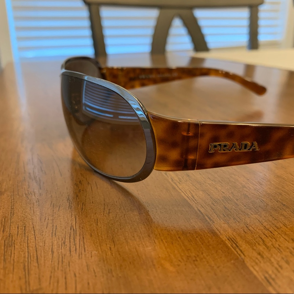 Prada sunglasses. Unisex.  Good condition but is missing left nose cushion